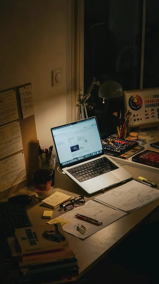 An open laptop on a desk in the evening