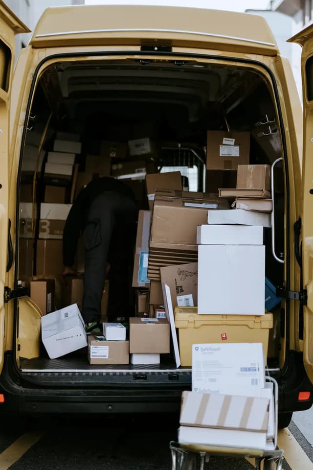 The back of a delivery van stacked with parcels