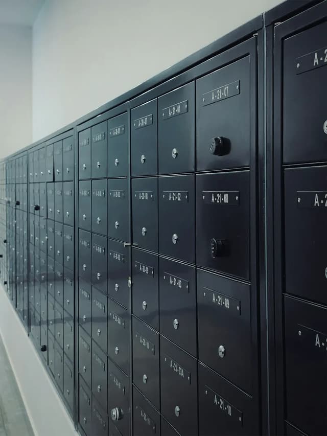 A wall of numbered mailboxes in an apartment building